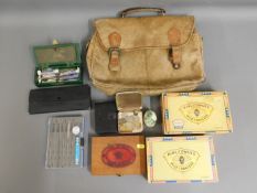 A leather satchel, two drawing sets, two cigar box