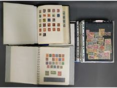 Three stamp albums including stamps from Britain,