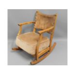 An upholstered rocking chair with leather back, 27