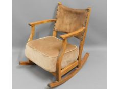 An upholstered rocking chair with leather back, 27
