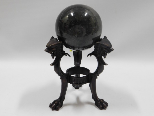 A polished marble ball with bronze stand, 8in tall