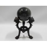 A polished marble ball with bronze stand, 8in tall