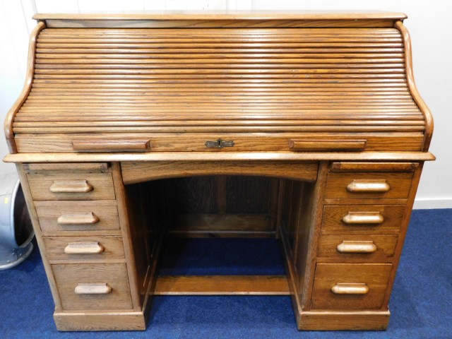 An oak roll top desk, 54.5in wide x 27in deep x 46