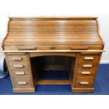 An oak roll top desk, 54.5in wide x 27in deep x 46