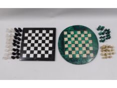 A malachite chess set twinned with a marble