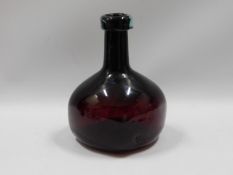 An onion shaped wine bottle, 7in tall x 4.5in wide