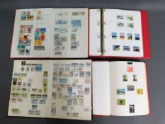 Four stamp albums including British, Australian &