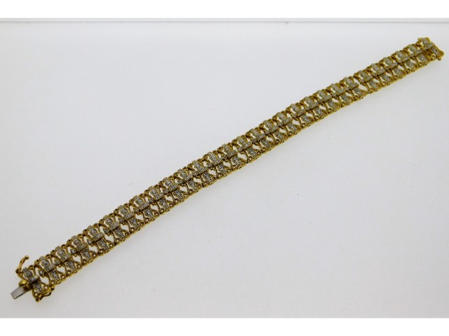 A ladies 18ct gold & diamond bracelet, fault to tw