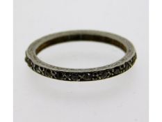 An antique platinum eternity ring set with diamond