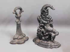Two Victorian cast iron doorstops including Mr. Pu