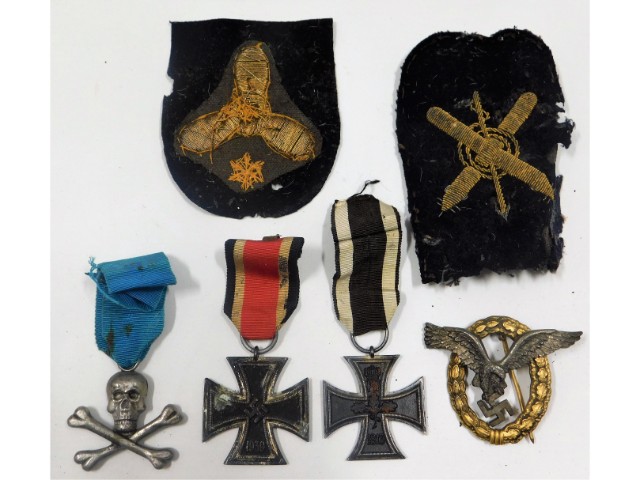 Two original German WW2 Iron cross medals, a Luftwaffe badge, a Nazi SS skull & cross bones badge &