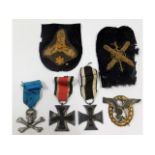 Two original German WW2 Iron cross medals, a Luftwaffe badge, a Nazi SS skull & cross bones badge &