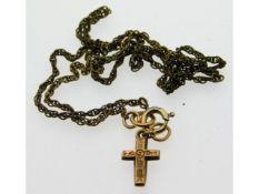 A 9ct gold cross with yellow metal chain