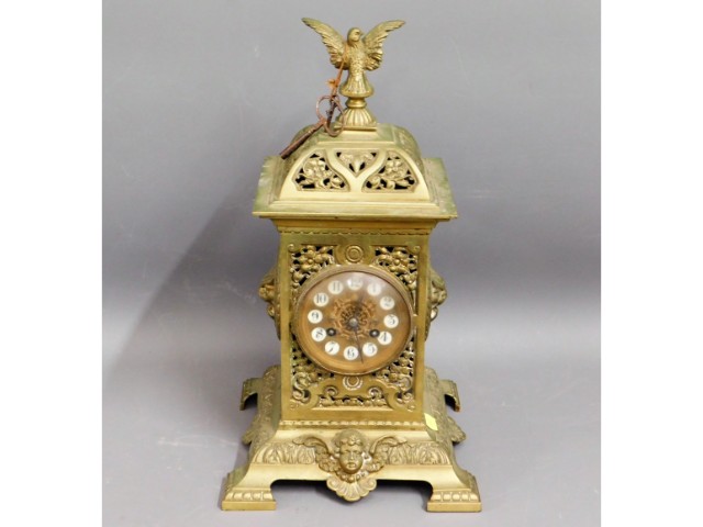 A decorative brass clock, 16.5in tall