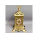 A decorative brass clock, 16.5in tall