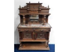 A carved oak ornate buffet with marble top & mirro