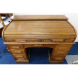 An oak roll top desk, faults to top, 48in wide x 2