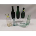 A collection of vintage bottles including R. Cundy