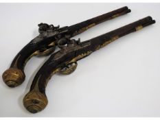 A matching pair of 18th/19thC. flintlock pistols, possibly Ottoman Empire, 18.75in long, by G. Stron