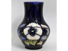 A Moorcroft vase decorated with pansies, green sig