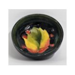 A small Moorcroft pottery leaf & berry bowl, signe
