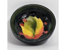 A small Moorcroft pottery leaf & berry bowl, signe