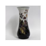 A Moorcroft pottery vase decorated with berries &