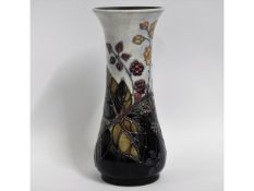 A Moorcroft pottery vase decorated with berries &