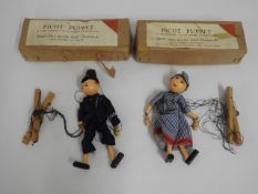 Two boxed Picot puppets depicting policeman & lady