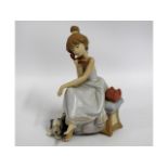 A Lladro porcelain figure of girl seated on phone