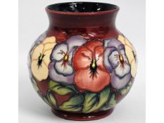 A Moorcroft pansy vase with yellow, lilac & red pa