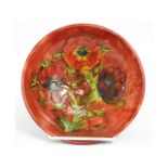 A Moorcroft pottery flambe bowl with floral decor,