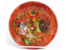 A Moorcroft pottery flambe bowl with floral decor,