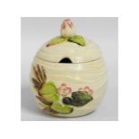 A Clarice Cliff Bizarre preserve jar, 4.25in tall