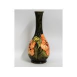 A Moorcroft pottery vase with floral decor, painte