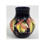 A Moorcroft pottery leaf & berry vase, blue signat