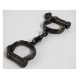 A WW2 set of military handcuffs with broad arrow m