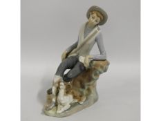 A Lladro figure of boy with dog, 7.25in tall