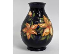 A Moorcroft pottery vase with floral decor, impres