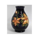 A Moorcroft pottery vase with floral decor, impres