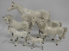 A family of six Beswick grey horses, largest 13.75