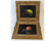 A pair of gilt framed still life oils on panel, in