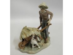 A Lladro porcelain figure of boy with dog & wheelb