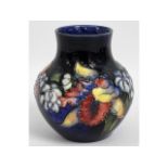 A Moorcroft pottery vase with floral decor, blue s