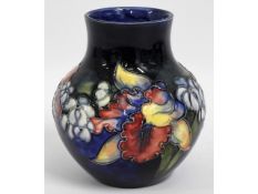 A Moorcroft pottery vase with floral decor, blue s