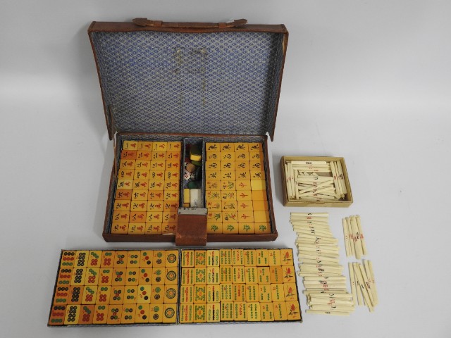 A cased mahong set with a box of bone counters (co