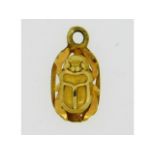 A yellow metal scarab beetle pendant, electronically tests as 18ct gold, 0.8g, 13mm high