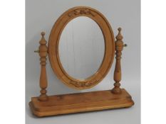 An oval pine dressing table mirror, 21.5in high