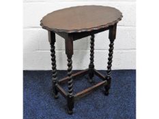 An oval oak occasional table with piecrust edge &