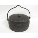 A large cast iron Siddons lidded cauldron, 17in high x 16.5in wide x 11.5in deep twinned with two fl